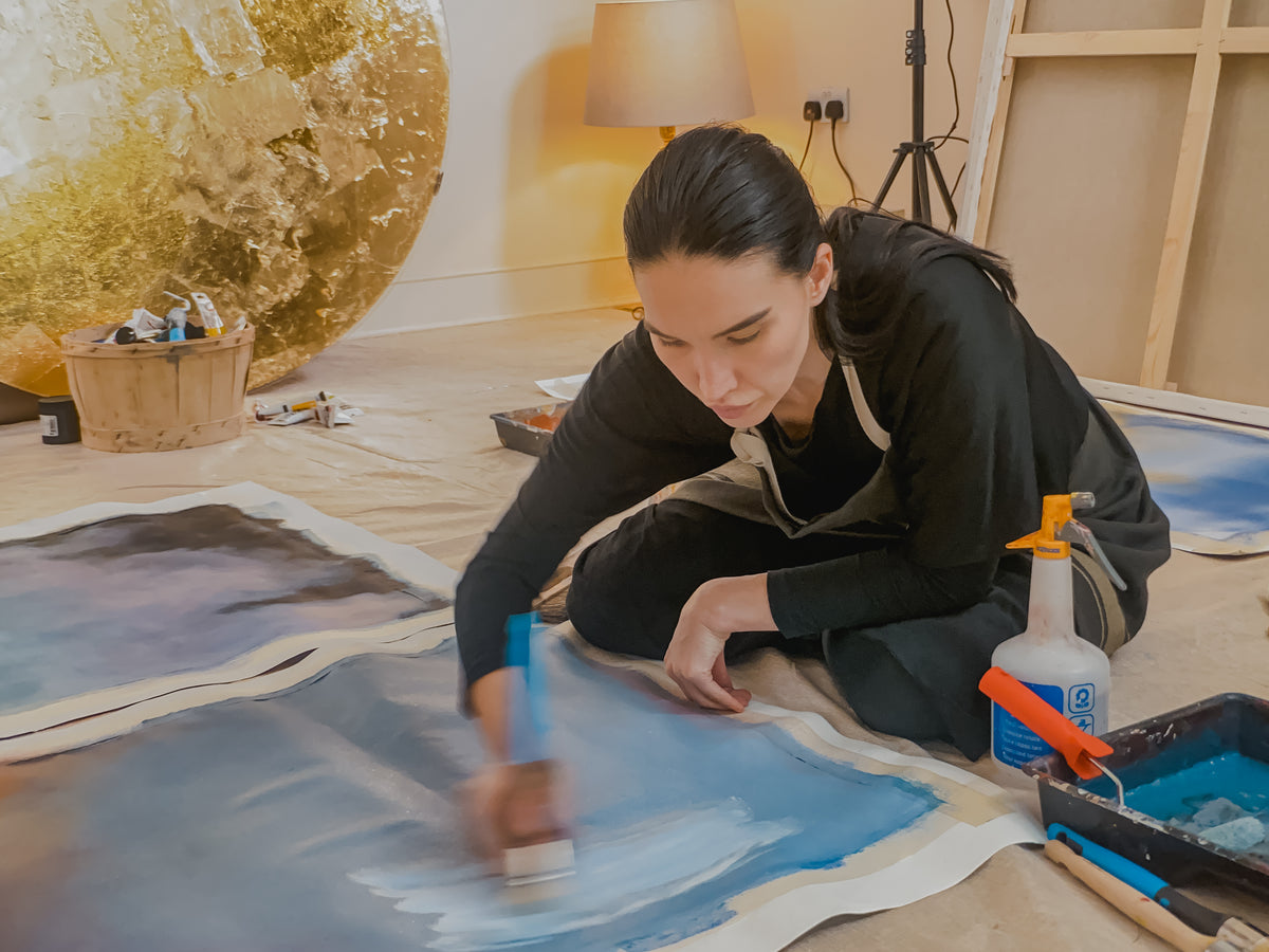 Aigana Gali working on a painting in her studio